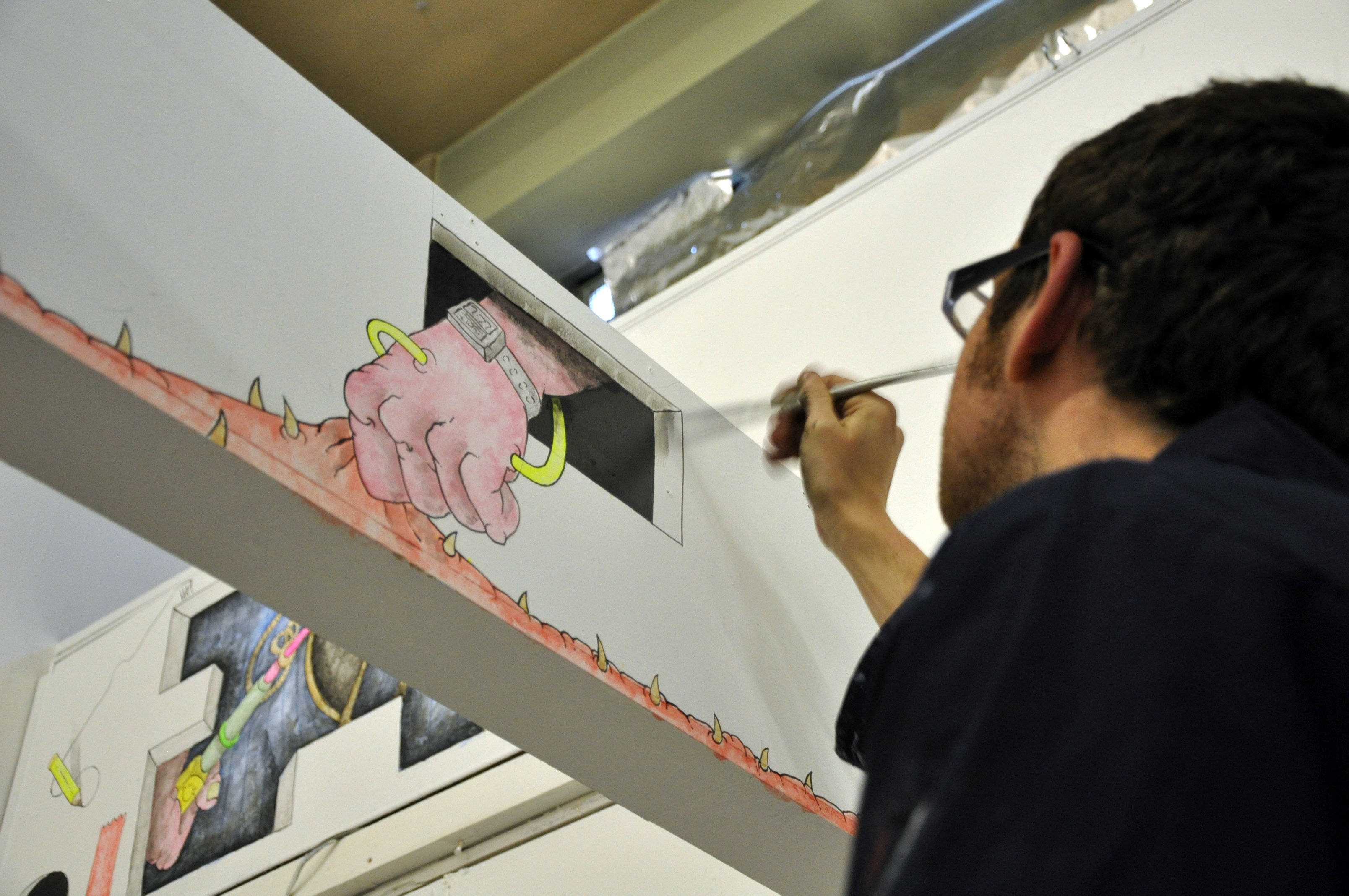 Paul at work doing wall mural for an exhibition